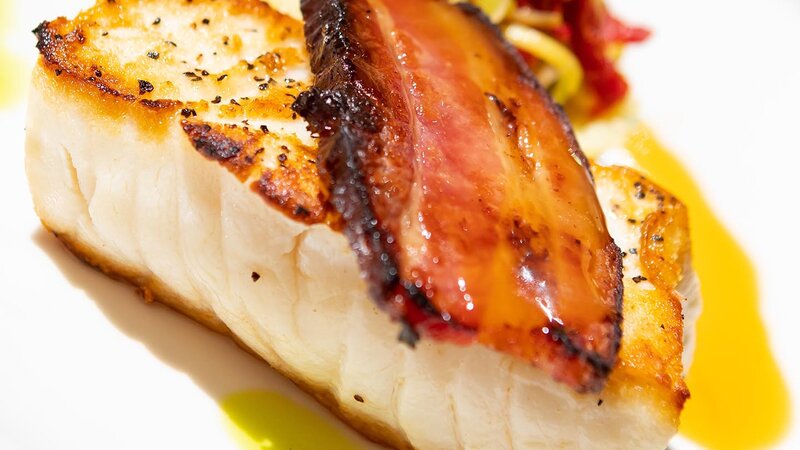 Chilean seabass topped with applewood bacon served with sherry seafood broth