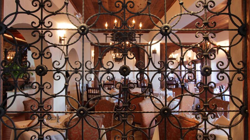 Cast iron gate with view of dining room